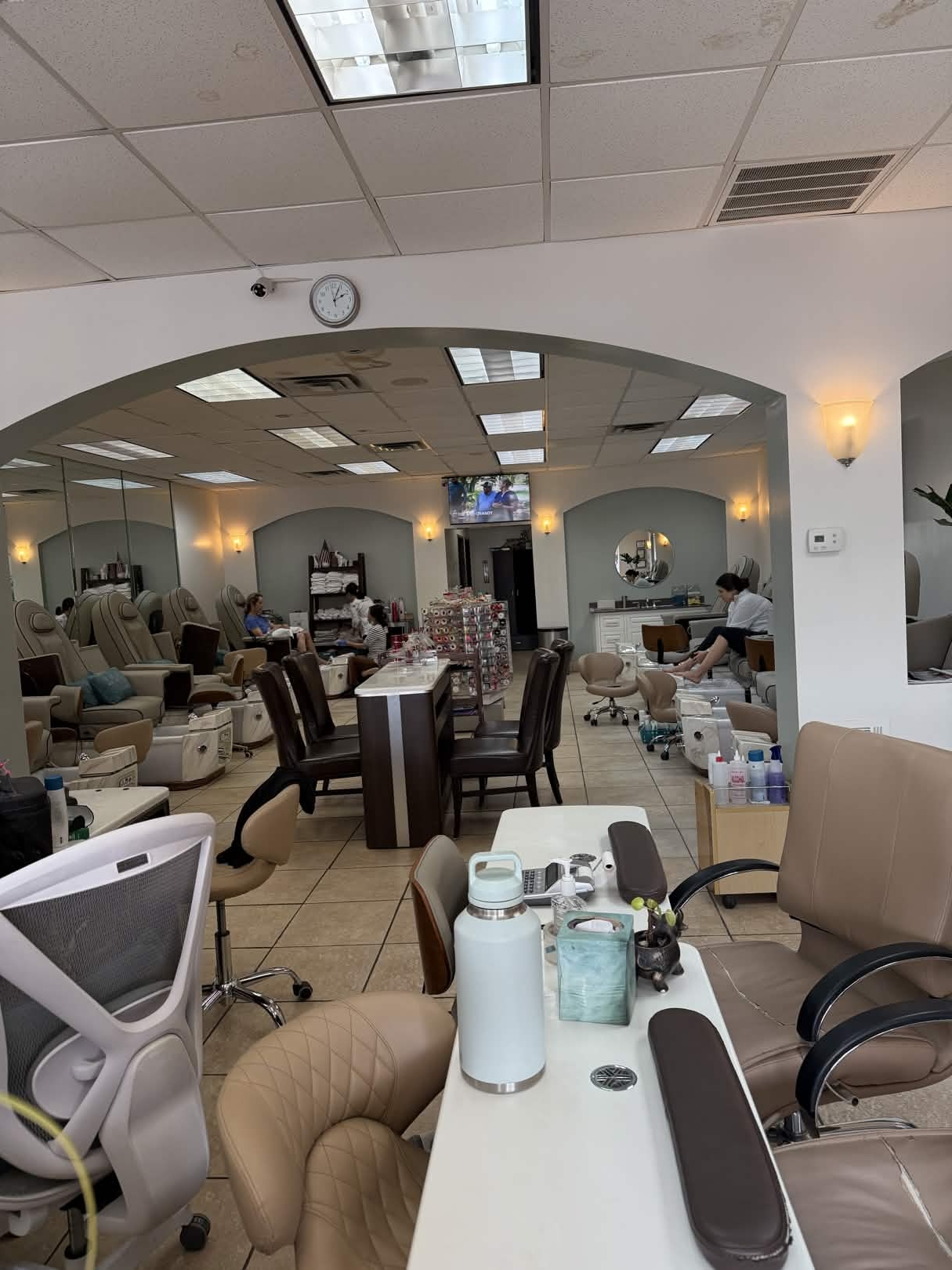 Interior of Nails Labelle in Dallas showing manicure stations and archways